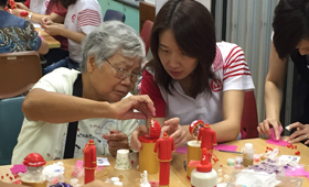 CMB Wing Lung Volunteer Team paired up with the grey hair ladies to make traditional Chinese wedding dress and phoenix crown headpiece with clay.